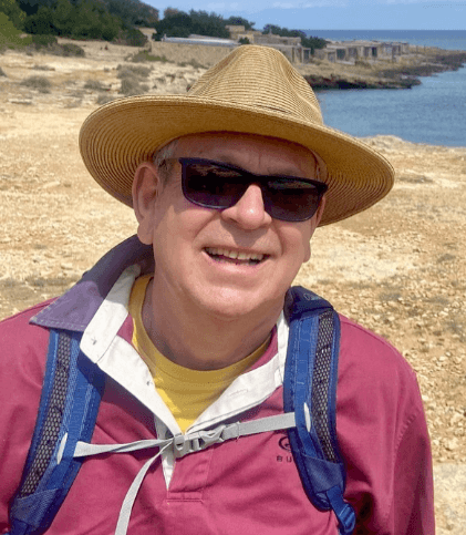 Portrait of John Marriott outdoors in a wide-brim hat